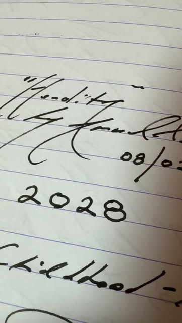 An image of ticket stub, diary and pen.