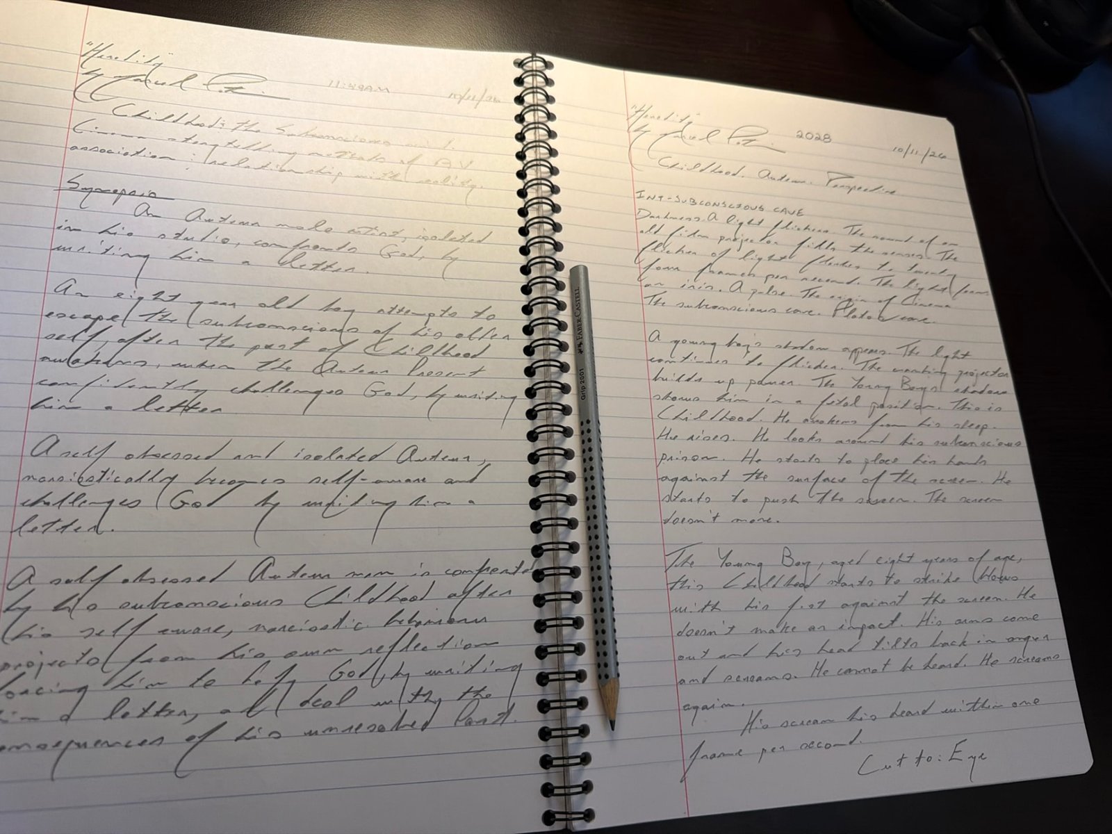 Open spiral notebook of Marcel Potvin's handwritten pages for Heredity — synopsis drafts on the left, the scene INT. SUBCONSCIOUS CAVE on the right, a pencil resting in the spine